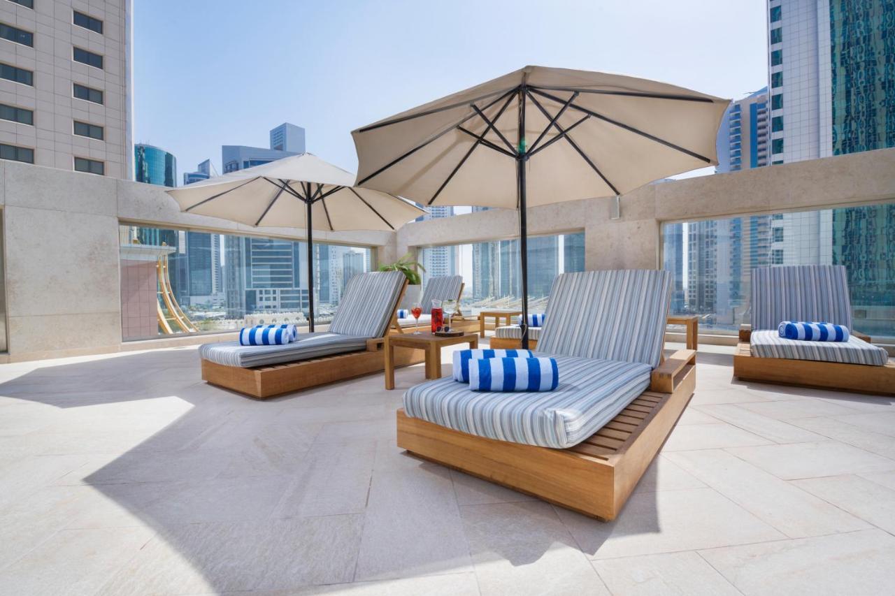 Wyndham Grand Doha West Bay Beach Kültér fotó The pool deck at the hotel
